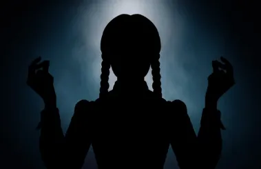 Picture of a shadowy silhouette of Wednesday Addams with her hands raised, snapping her fingers